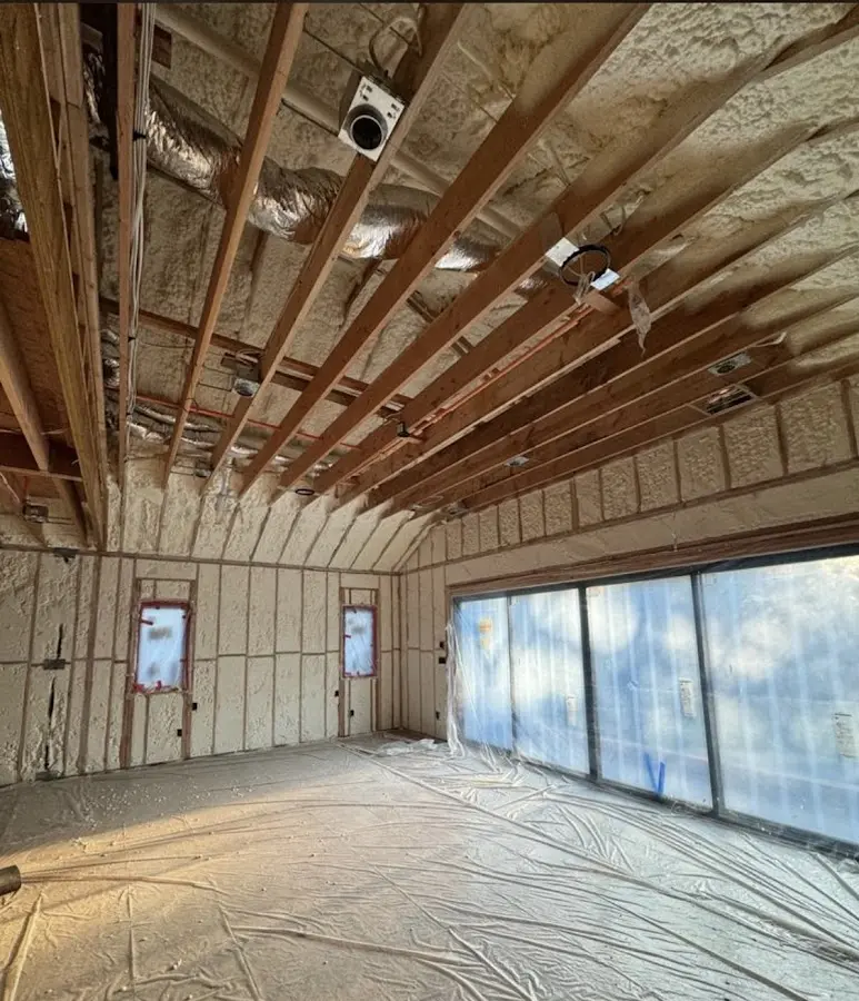 Interior walls and ceiling insulated with spray foam during new construction in Monroe